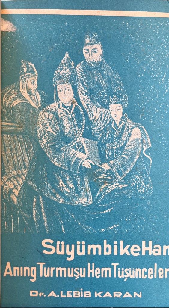 A page with an image of a woman surrounded by three men, all four of them in traditional Tatar clothing, with text at the bottom in Latin script. The images and the text are in white on a light blue background.