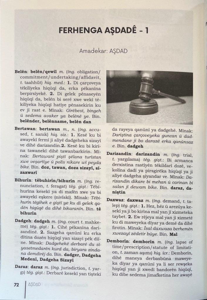 A black and white page of text in Latin script with a small photograph in the top-right corner of a judge's gavel 