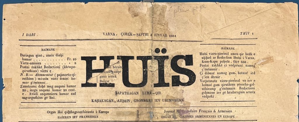 A long page of newspaper frayed at the ends and missing an oval section in the middle, printed on in black ink with Latin characters, divided into three columns, with four bold characters at top